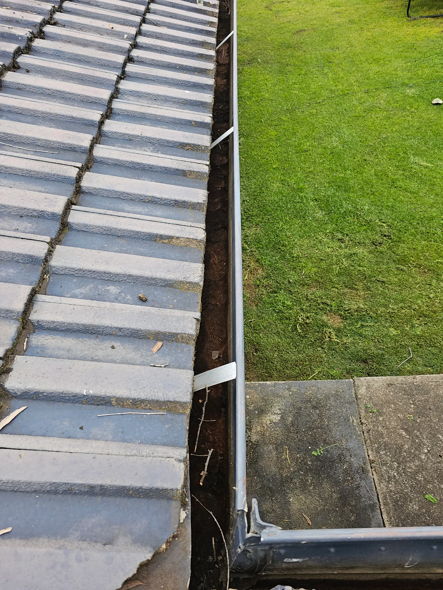 The same eaves gutter cleared and draining freely after PVS Plumbing cleaned it