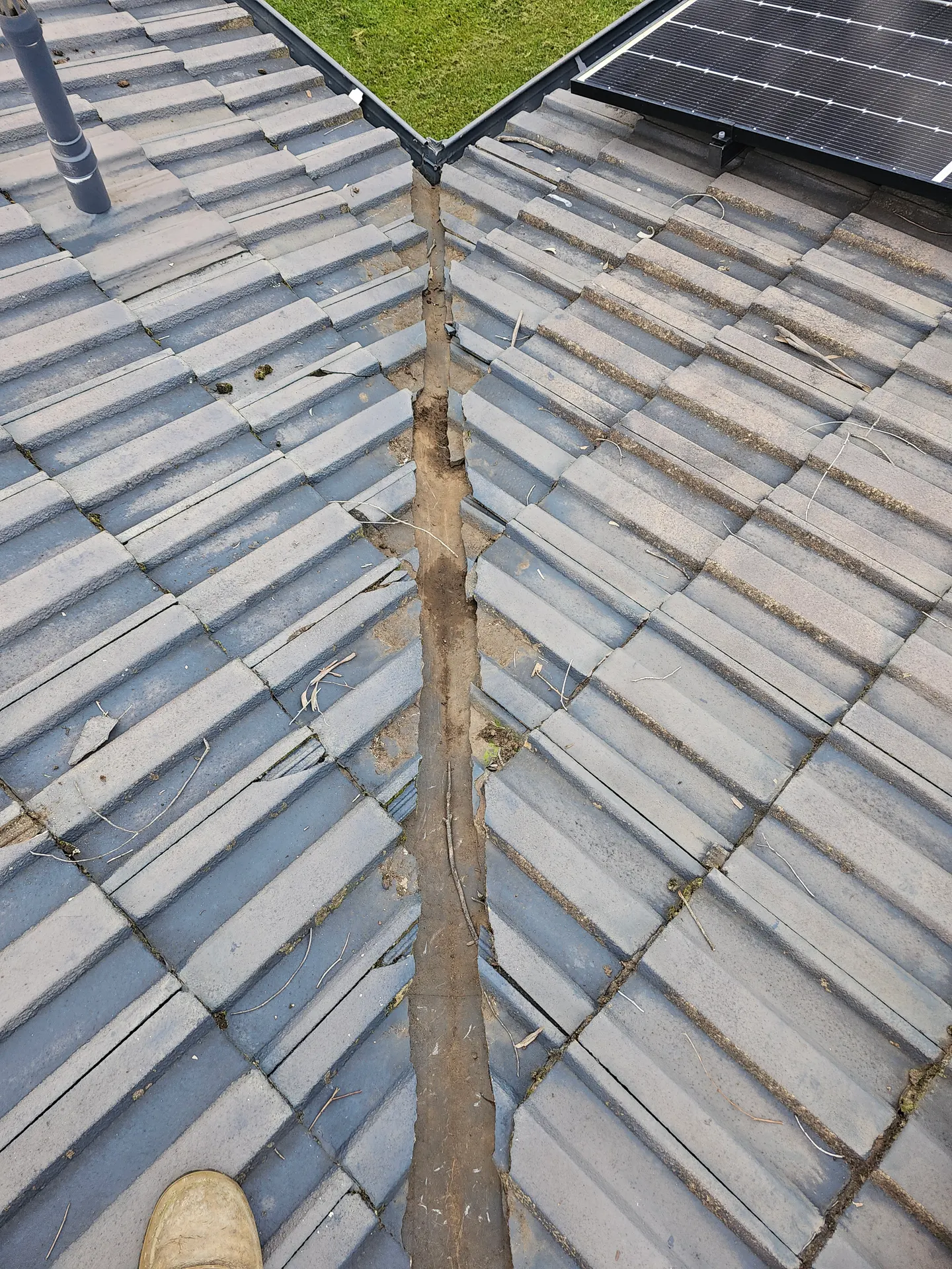 The same roof valley cleared back to a bare metal tray after PVS Plumbing cleaned it